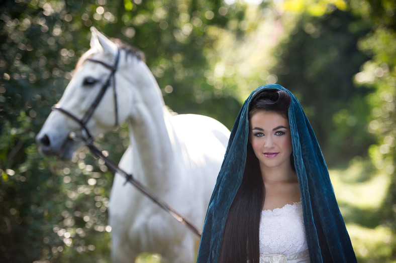 Girl with cape and white horse