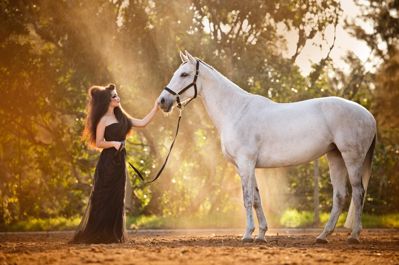 Girl with black Olivelli wedding dress and horse