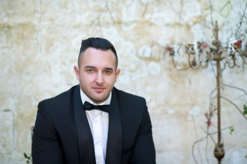 Man in tux with textured wall
