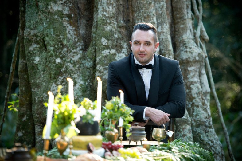 Groom with forrest themed wedding decor