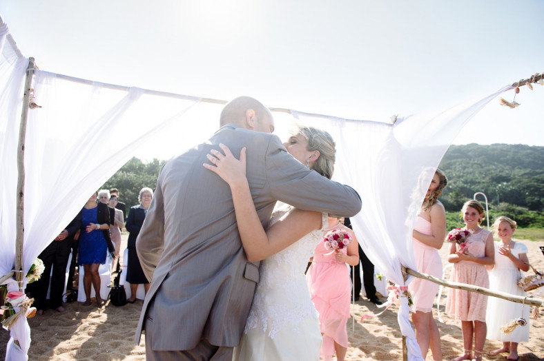 beach wedding first kiss