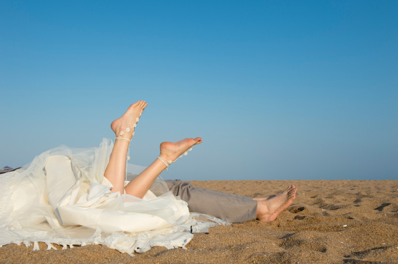 bride and groom feet on a beach