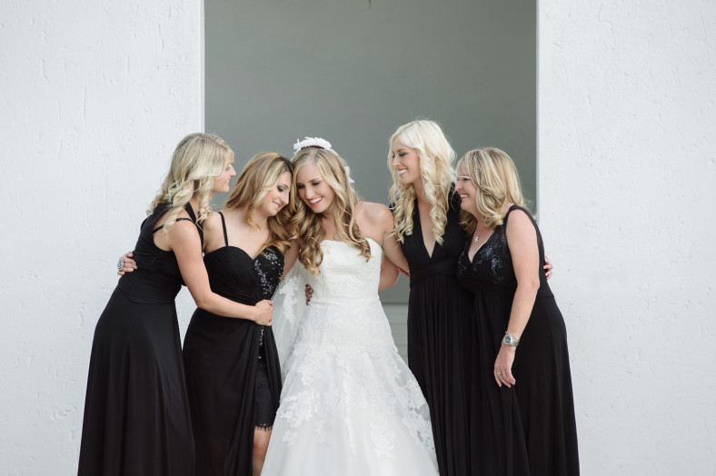 Bride with bridesmaids in black Bride getting into dress Wedding at the Oyster Box Hotel Durban South Africa