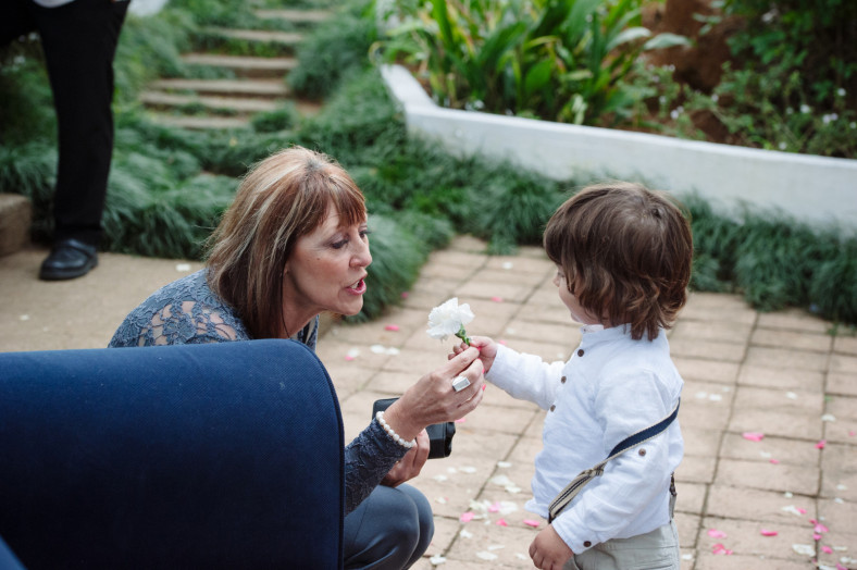 boy giving woman a flower