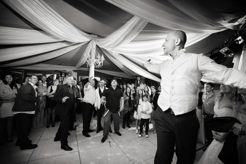 Groom throwing garter