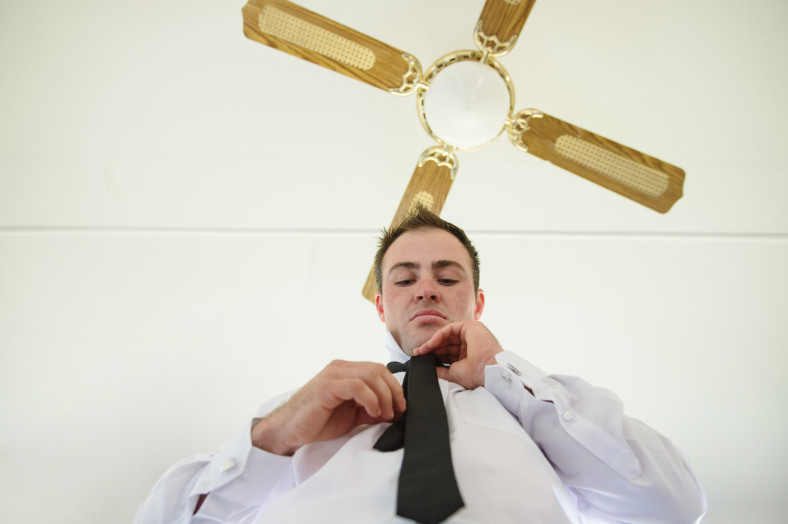 Groom tying tie