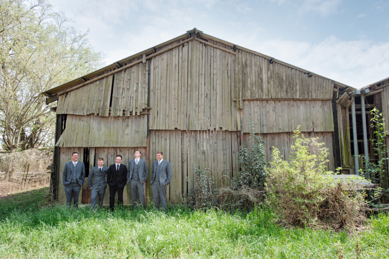 Groom with groomsmen on barn door