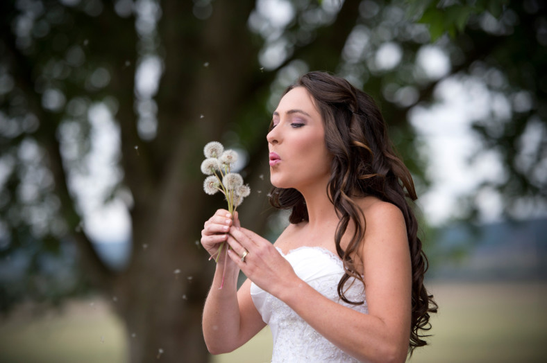 bride blowing dandelions