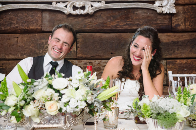 bride and groom listening to speeches