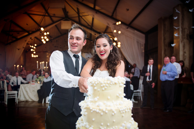 bride and groom cut the cake