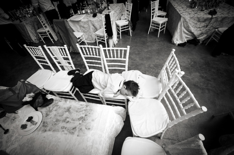 child asleep on chairs