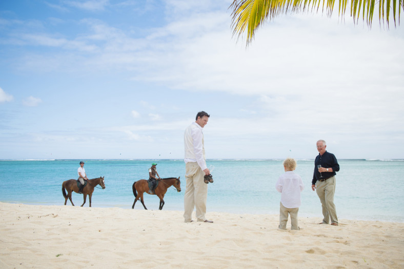 man on beach with horses