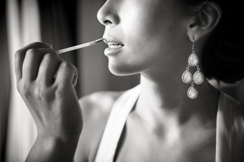 bride applying lipstick