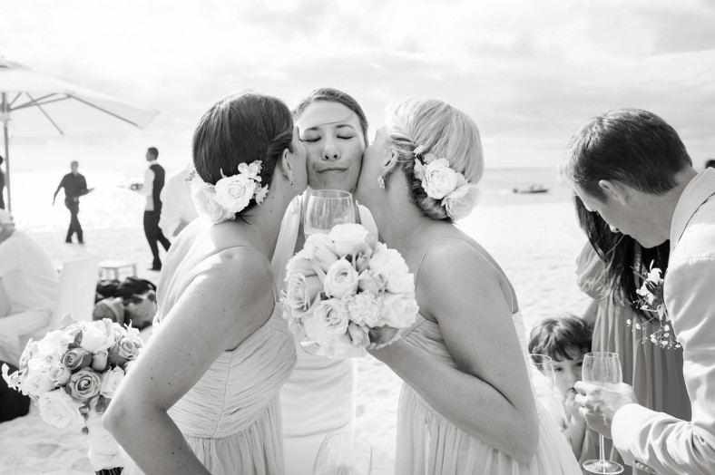 bridesmaids kissing bride
