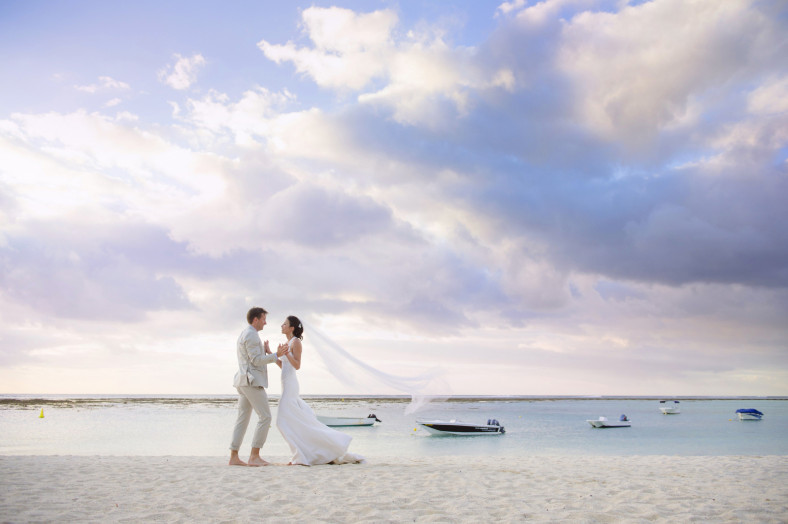 Bride and groom on La Morne beach St Regis