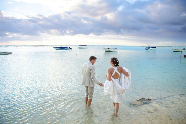 Bride and groom on La Morne beach St Regis