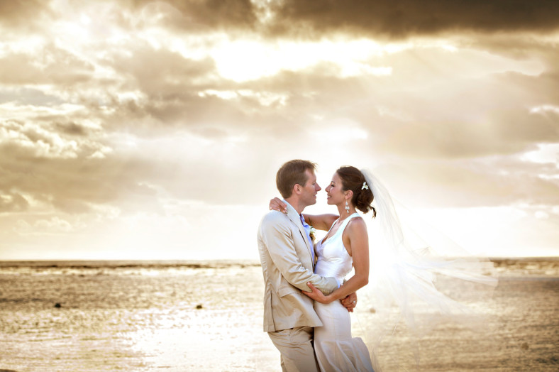 Bride and groom on La Morne beach St Regis