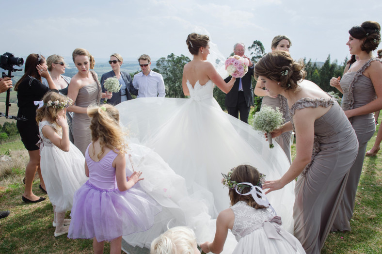 girls fixing wedding dress