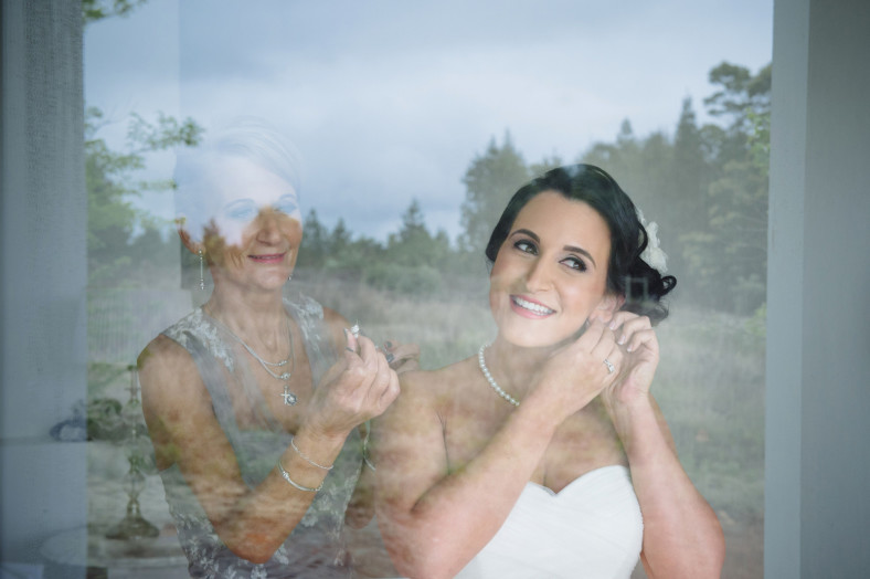 bride putting on earrings