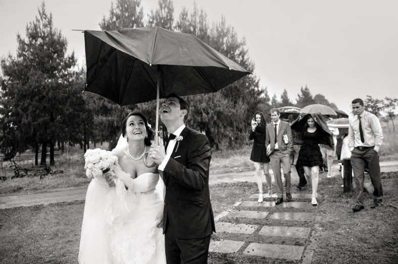 bride and groom in rain