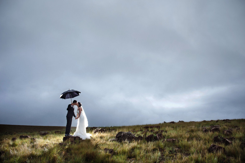 bride and groom with umbrella