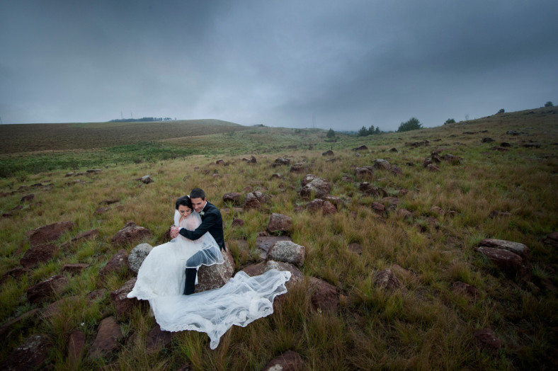 bride and groom in field
