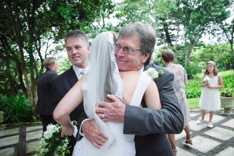 father hugs bride
