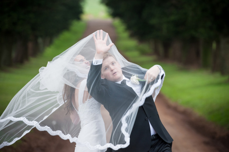 groom fighting veil