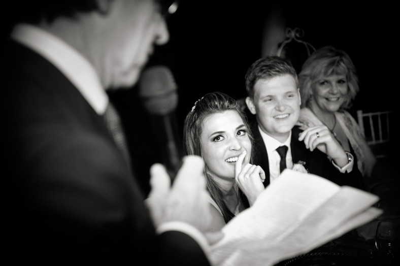 bride and groom listening to speeches