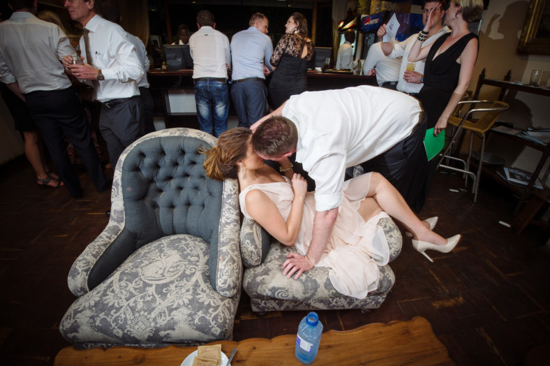 couple kiss in crowded room