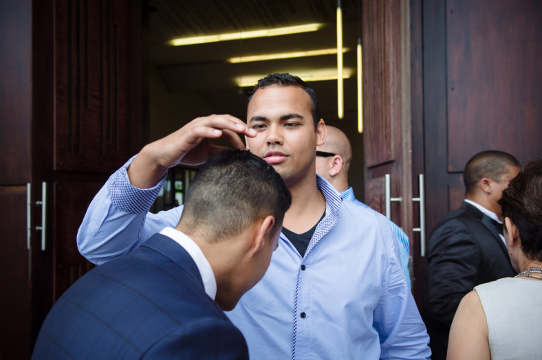 friend checking grooms hair