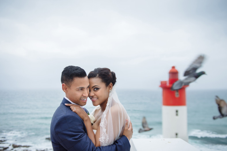 bride and groom at lighthouse