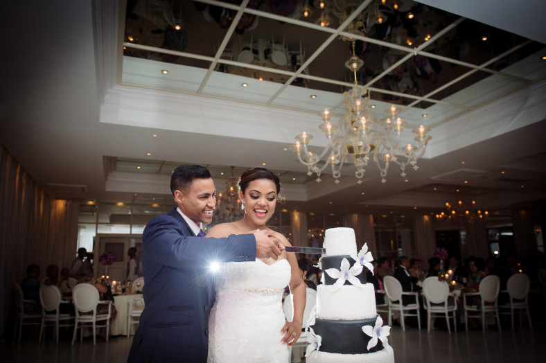 bride and groom cutting the cake