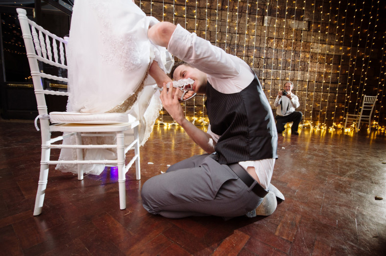 groom biting garter