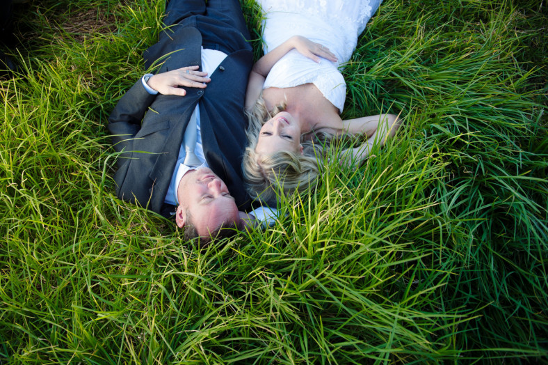 bride and groom in grass