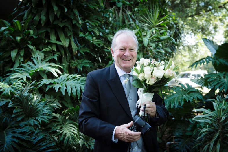 Father of the bride with bouquet