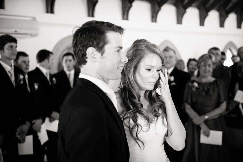 Bride crying at wedding with groom