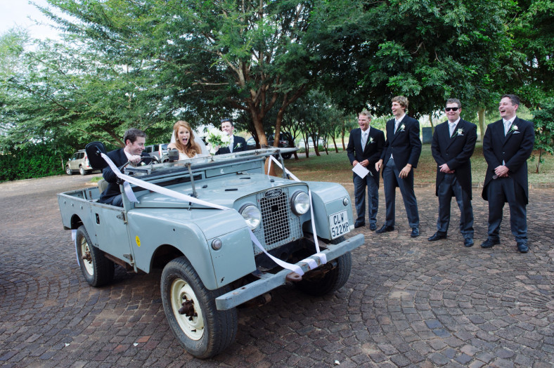 Bride and Groom in a land rover