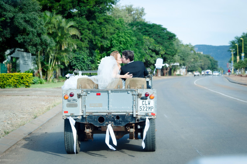 Bride and Groom in a land rover