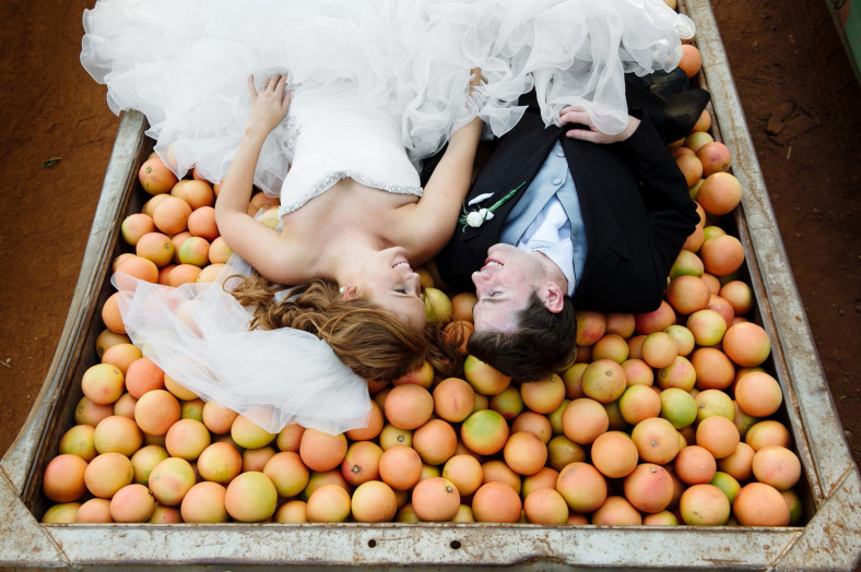 Bride and Groom on a pile of fruit