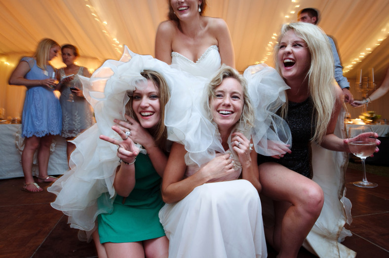 Girls hiding under wedding dress