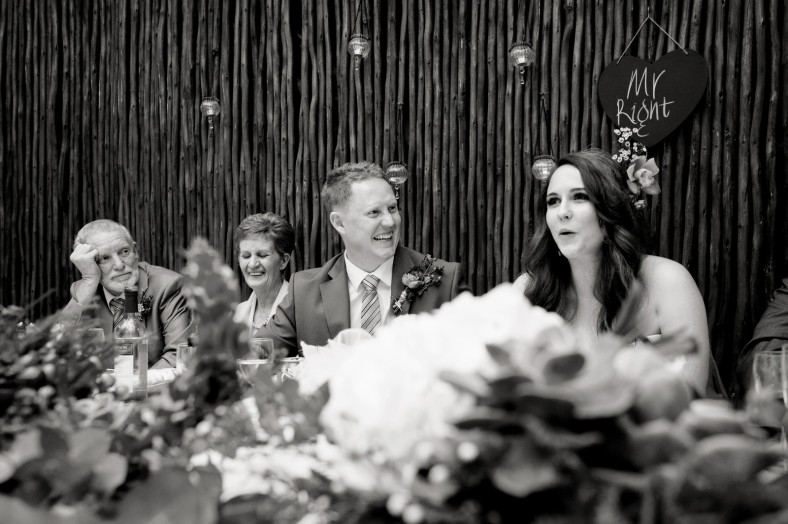 bride and groom laughing at speeches