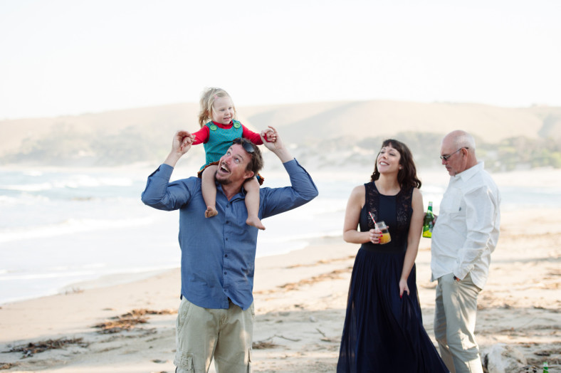 family playing on a beach