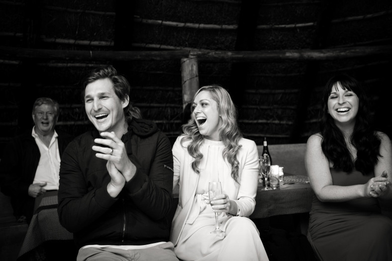 guests laugh at wedding speeches