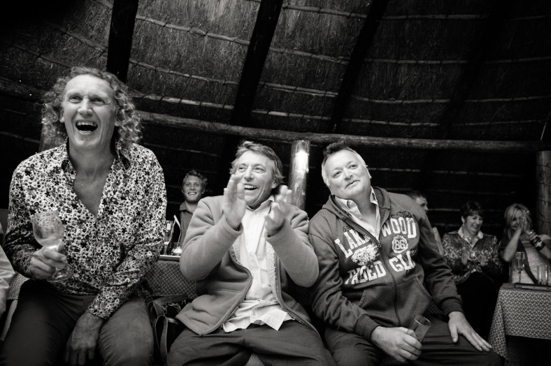 guests laugh at wedding speeches