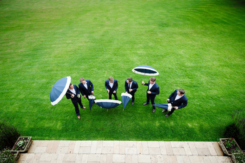 Groomsmen with umbrellas