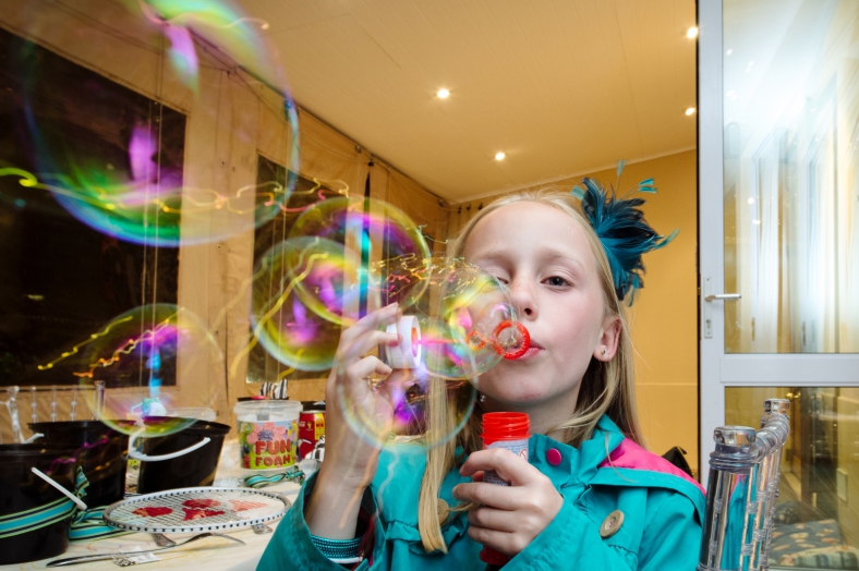 Girl blows bubbles