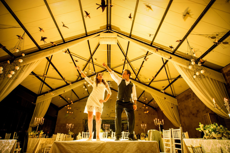 Bride and Groom dancing on tables