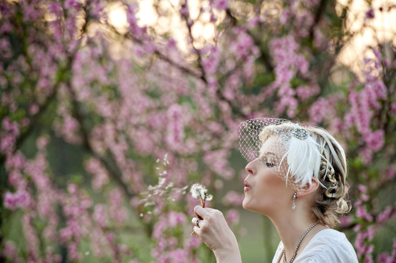 Bride blows dandelion