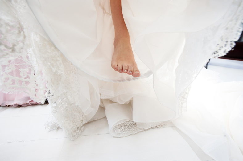 Bride putting on dress